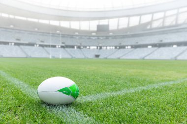 Close-up of Rugby ball on a grass in the empty stadium clipart