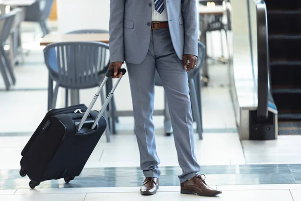 スーツケースを持って立っている男性幹部の低いセクション — ストック写真