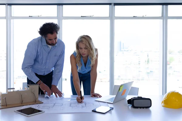 Front View Attentive Caucasian Male Female Architects Working Blueprint Table — ストック写真