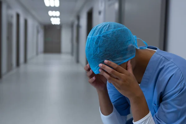 Close Tensed Mixed Race Female Surgeon Sitting Corridor Head Hands — Stock Photo, Image