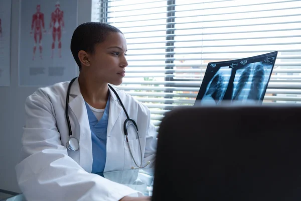 Side View Mixed Race Female Doctor Examining Ray Report While — Stock Photo, Image