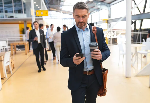 Front View Caucasian Businessman Using Mobile Phone While Walking Corridor — Stock Photo, Image