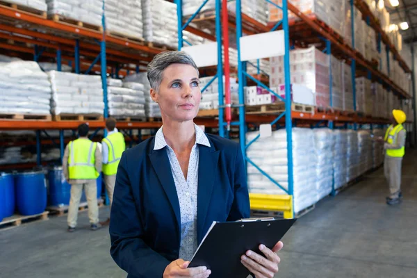 Front View Confident Mature Caucasian Female Manager Checking Stocks Clipboard — Stock Photo, Image