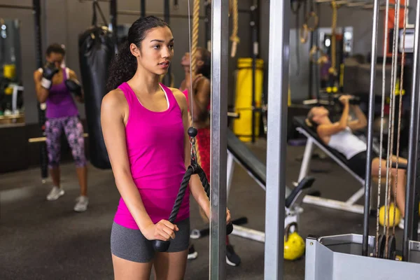 Front View Caucasian Female Athlete Exercising Triceps Push Machine Fitness — Stockfoto