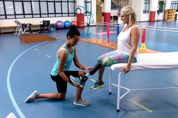 Side View African American Female Trainer Adjusting Prosthetic Leg Disabled — ストック写真