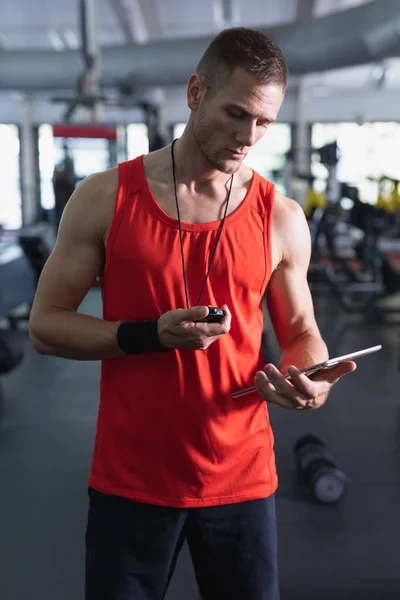 Front View Caucasian Male Trainer Using Digital Tablet Fitness Center — Stockfoto