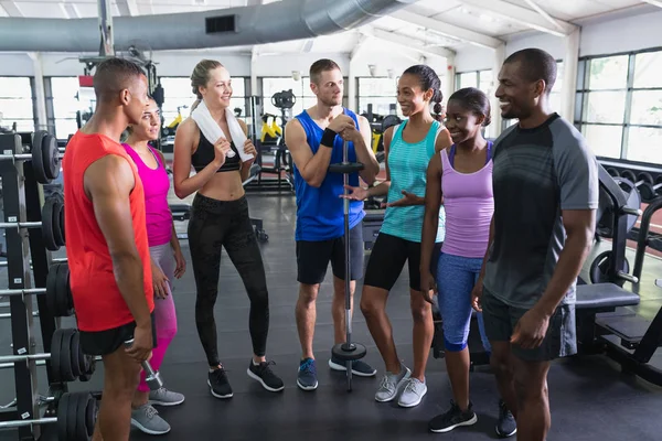在健身中心 各种适合的人互相交流的正面观点 健康的人锻炼身体和训练的明亮的现代体育馆 — 图库照片