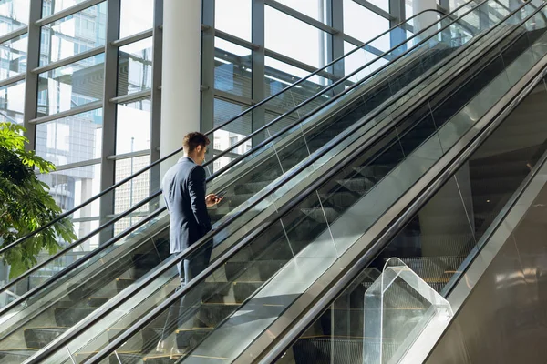 Teljes Hosszúságú Oldalnézetből Fiatal Üzletember Megy Mozgólépcső Egy Modern Irodaház — Stock Fotó