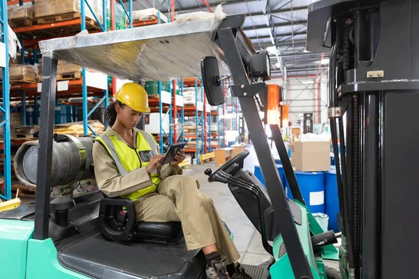 Female Staff Using Digital Tablet While Sitting Forklift Warehouse — Stok fotoğraf