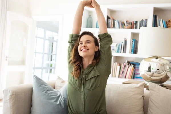 Caucasian Woman Spending Time Home Sitting Sofa Stretching Her Arms — Stock Photo, Image