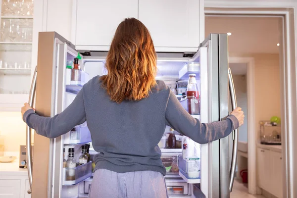 白人女性は台所で家で時間を過ごし 冷蔵庫を開けます 家庭での生活隔離 コロナウイルスの間の隔離されたロックダウンの社会的距離は19パンデミックを克服 — ストック写真