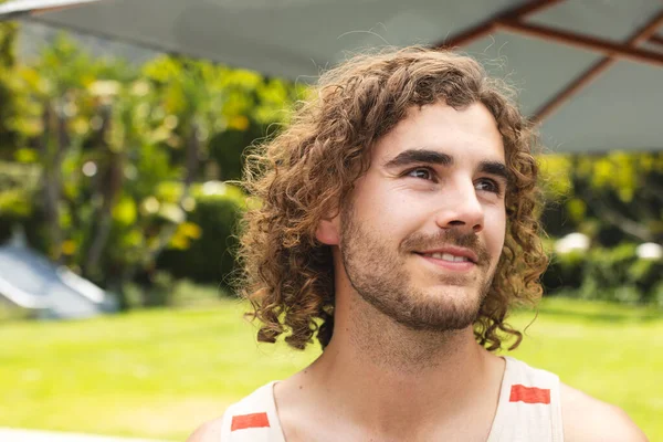 Young Caucasian Man Curly Hair Smiles Outdoors His Casual Tank — Stock Photo, Image