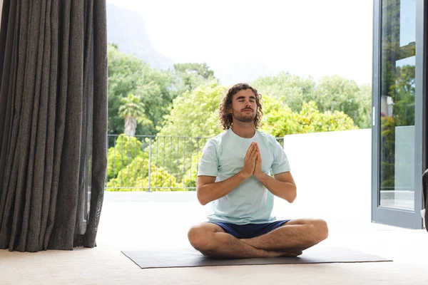 Young Caucasian Man Practices Yoga Serene Indoor Setting Focused Hands — Stock Photo, Image