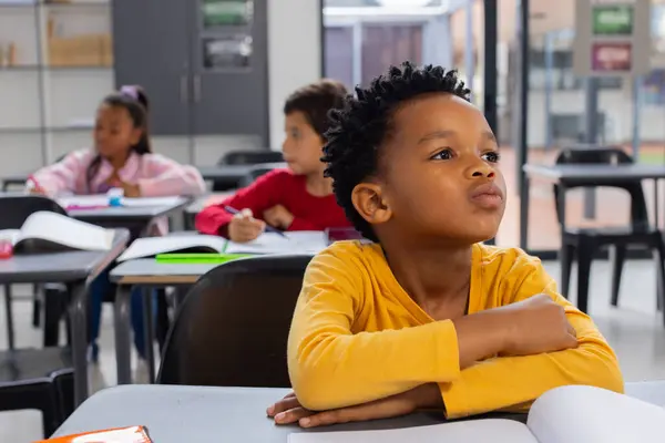 Biracial Boy Yellow Shirt Looks Thoughtful School Classroom Setting African — Stock Photo, Image