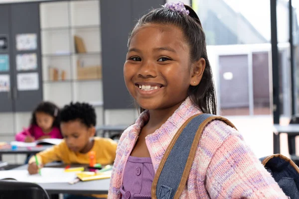 Biracial Girl Purple Hair Accessory Smiles Wearing Backpack School Classroom — Stock Photo, Image