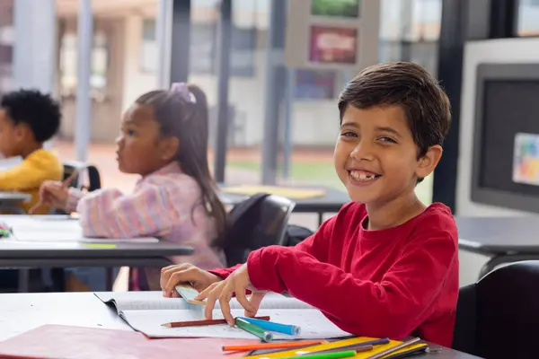 Biracial Boy Bright Smile Sits Desk School Classroom Dark Hair — Stock Photo, Image