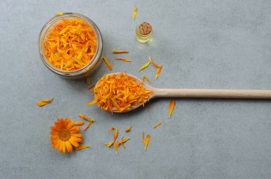 Calendula officinalis çiçekleri ve taç yaprakları bitkisel yağ ya da başka bir amaç için hazırlanıyor. Şifalı bitki. Çiçek arkaplan. Düz, yatay.