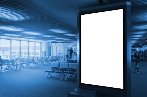 blank advertising billboard or light box showcase with waiting zone at airport, copy space for your text message or media content, advertisement, commercial and marketing concept, blue color tone