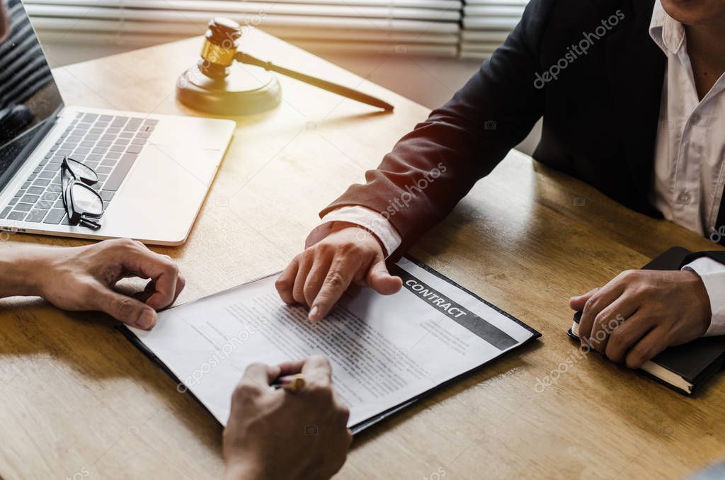 Realtor - young man customer signing contract for buying house with real estate broker in suit at estate agent office, investment, home loan contract, buy and sell home, real estate, insurance concept