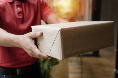 Ev, kargo Sevkiyat, ekspres teslimat hizmeti, online alışveriş ve lojistik konsepti kurye gelen parsel posta kutusu alıcı müşteri kırmızı üniforma genç teslimat hizmeti adam el