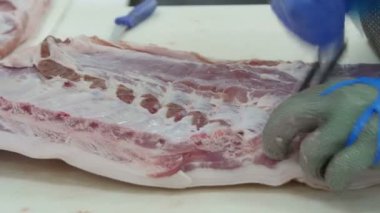 Et işleme fabrikasında et kesen kasap