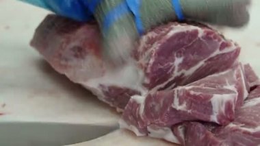 Et işleme fabrikasında et kesen kasap