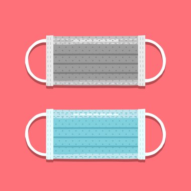 Pembe üzerinde iki cerrahi maske.