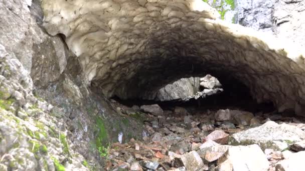 Ice grotto, a snow cave in the mountains in summer — Stock Video