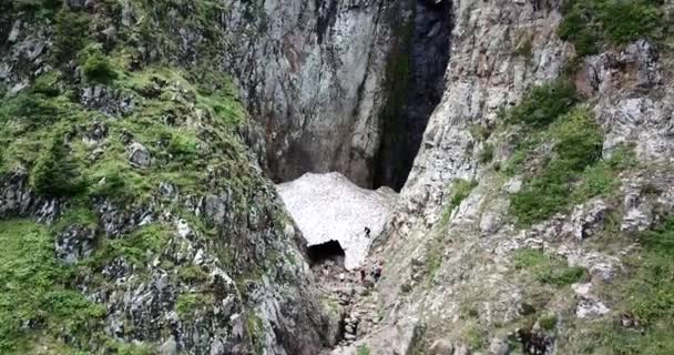 Eine Gruppe von Menschen in der Nähe einer Schneehöhle. Ansicht von oben. — Stockvideo