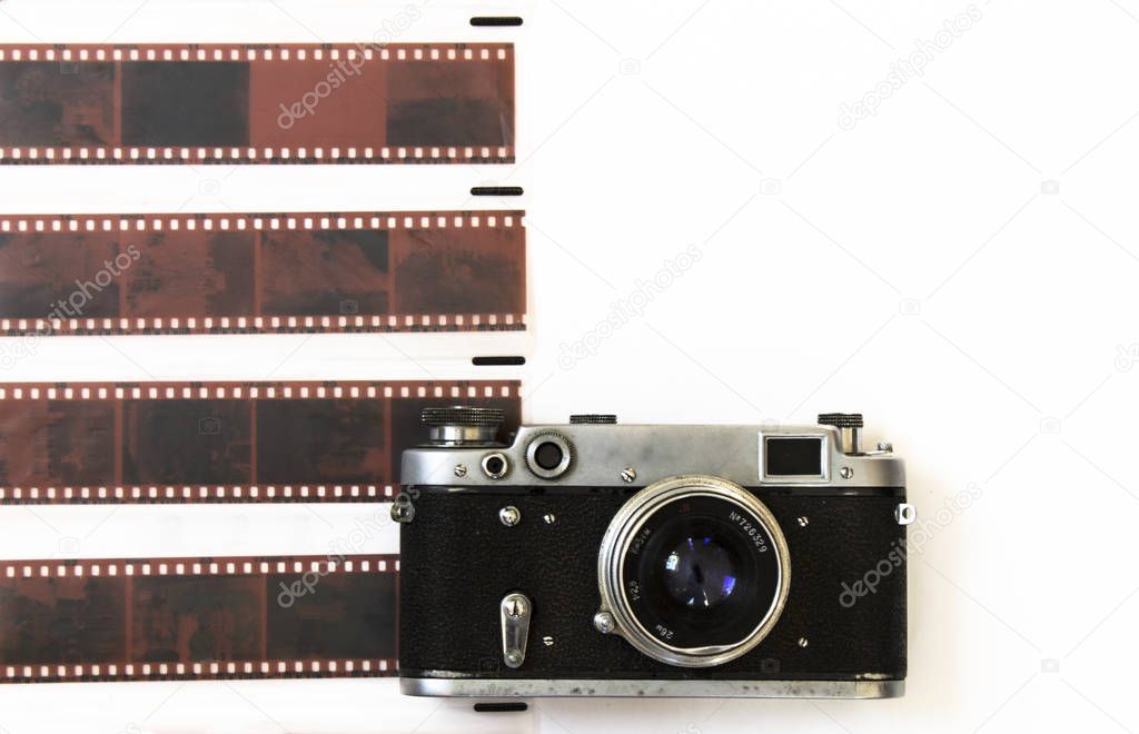 Film retro camera with cut film on white background for decoration.