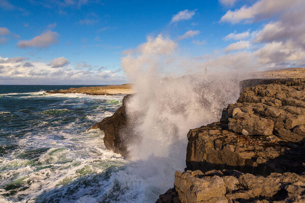 Coast Atlantic Ocean, Ireland- 07 November2015: People on the rocky coast of the North Atlantic Ocean, Burren Way.