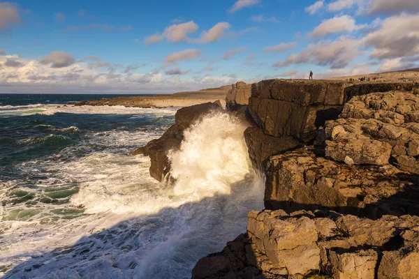 Coast Atlantic Ocean, Ireland- 07 November2015: People on the rocky coast of the North Atlantic Ocean, Burren Way.