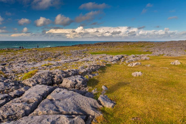 Coast Atlantic Ocean, Ireland- 07 November2015: People on the rocky coast of the North Atlantic Ocean, Burren Way.