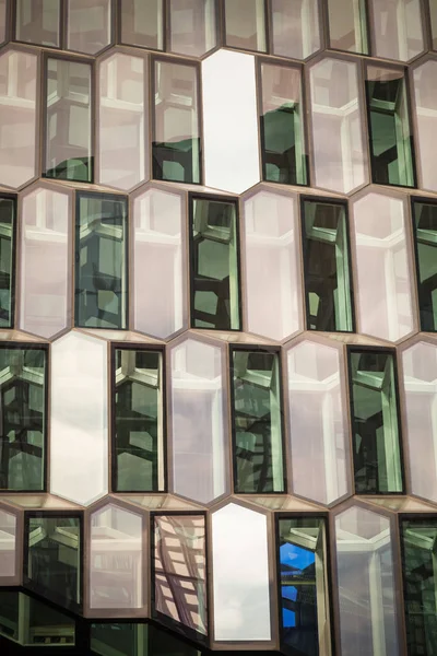 Windows of a modern office building in the form of honeycomb. Toned.