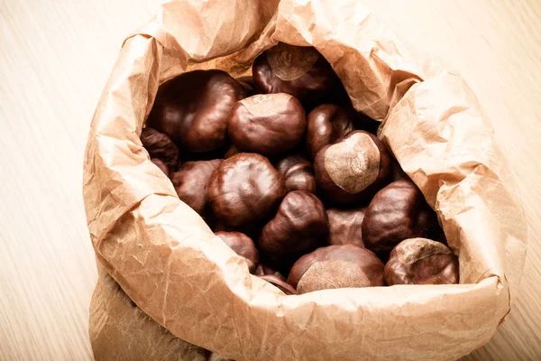 Chestnuts Paper Bag Light Wooden Table Toned — Stock Photo, Image