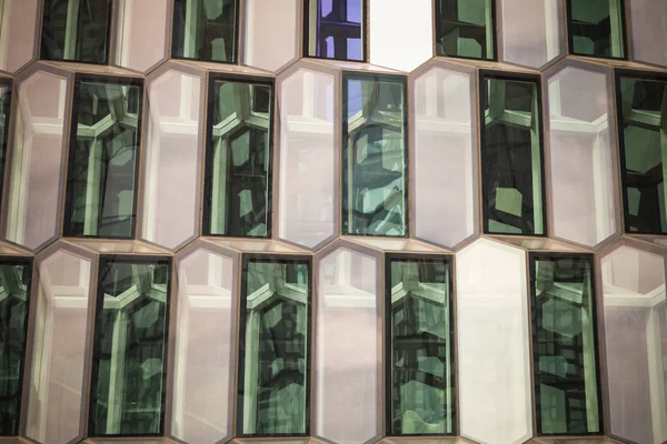 Windows of a modern office building in the form of honeycomb. Toned.