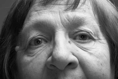 Close up studio portrait of elderly woman with hat. Sad. Toned. clipart