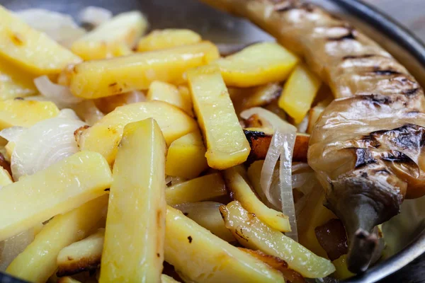 Heerlijke geroosterde aardappelen met ui en specerijen in een pan op Kitch — Stockfoto