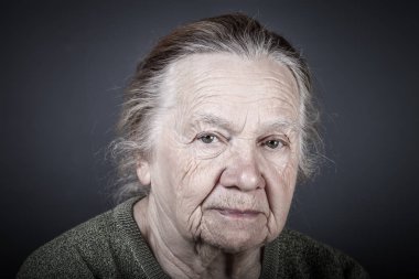 Portrait of elderly woman. Attentive look. Toned clipart