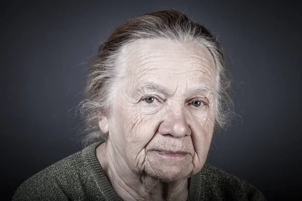 Portrait of elderly woman. Attentive look. Toned — Stock Photo, Image