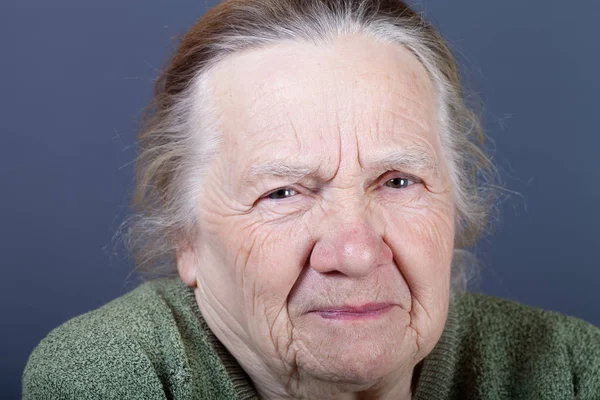 Portrait of elderly woman. Discontent — Stock Photo, Image