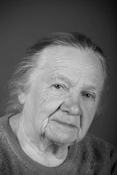 Portrait of elderly woman. Attentive look. Toned Stock Image