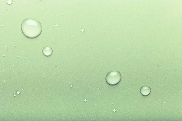 Drops of water on a color background. Green. Toned — Stock Photo, Image