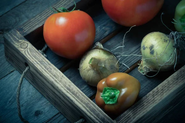 Fresh vegetables in a burned rustic texture box for background. — Stock Photo, Image