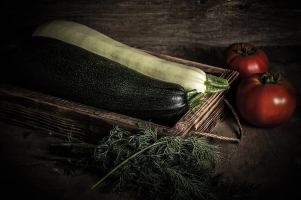 Fresh vegetables in a burned rustic texture box for background. — Stock Photo, Image