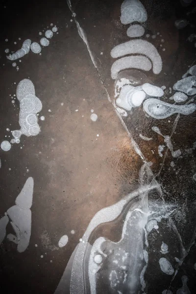 Abstract pattern of ice on the over of puddle. Toned — Stock Photo, Image