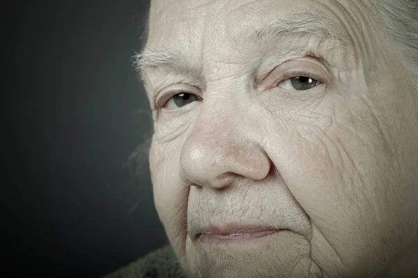 Portrait of elderly woman. Closeup view. Toned — Stock Photo, Image