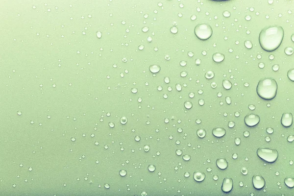 Gotas de água em um fundo a cores. Verde. Tonificado — Fotografia de Stock