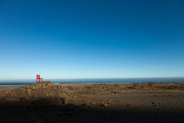 Red wooden chair on a empty stony landscape in Iceland — Stock Photo, Image