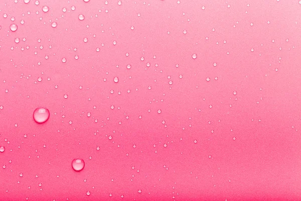 Gotas de água em um fundo a cores. Rosa. Tonificado — Fotografia de Stock